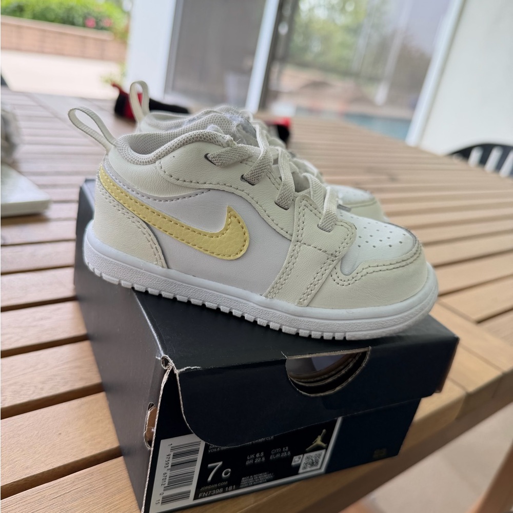 Nike Kids White Sneakers with Pale Yellow Swoosh